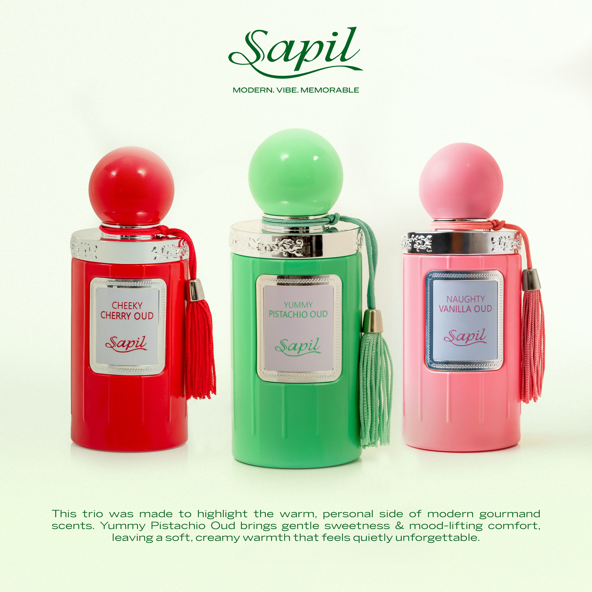 Sapil gourmand oud perfume collection featuring Cheeky Cherry Oud, Yummy Pistachio Oud and Naughty Vanilla Oud bottles in red, green and pink