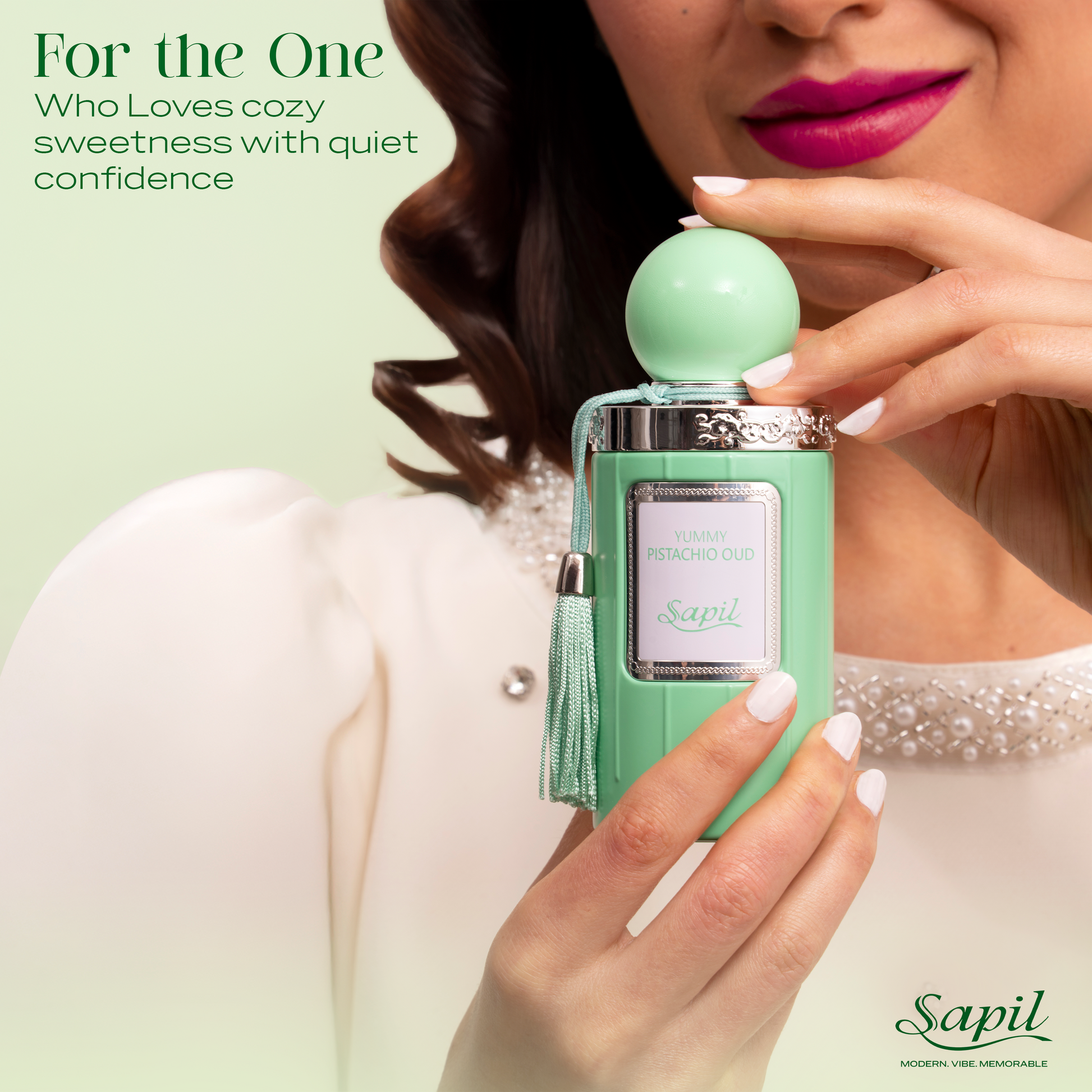 Close up of Sapil Yummy Pistachio Oud Eau de Parfum 100ml held by a woman, highlighting cozy sweet pistachio fragrance with soft oud and quiet confidence